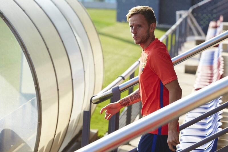 Barcelona midfielder Ivan Rakitic makes his way onto the training pitch. Alejandro Garcia / EPA