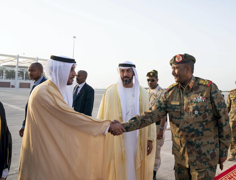ABU DHABI, UNITED ARAB EMIRATES - May 26, 2019: HE Humaid bin Saeed Al Neyadi, Deputy Director of the Office of the UAE Minister of Presidential Affairs (L) greets Lieutenant General Abdel Fattah Al Burhan Abdelrahman, Head of transitional military council of Sudan (R), at the Presidential Airport. Seen with HE Mohamed Mubarak Al Mazrouei, Undersecretary of the Crown Prince Court of Abu Dhabi (C).
( Mohamed Al Hammadi / Ministry of Presidential Affairs )
---