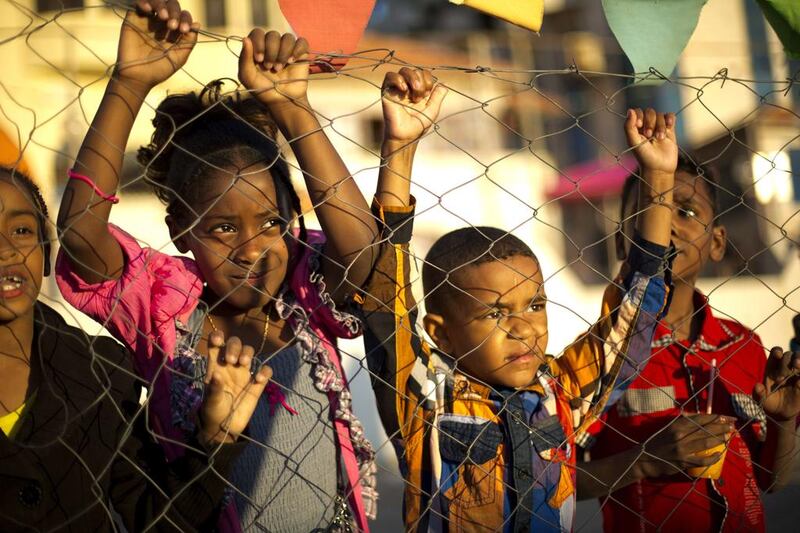 Palestinian children stand behind a fence near the beach during ‘Nakba’ day in Gaza City, Palestine.  Mohammed Abed / AFP