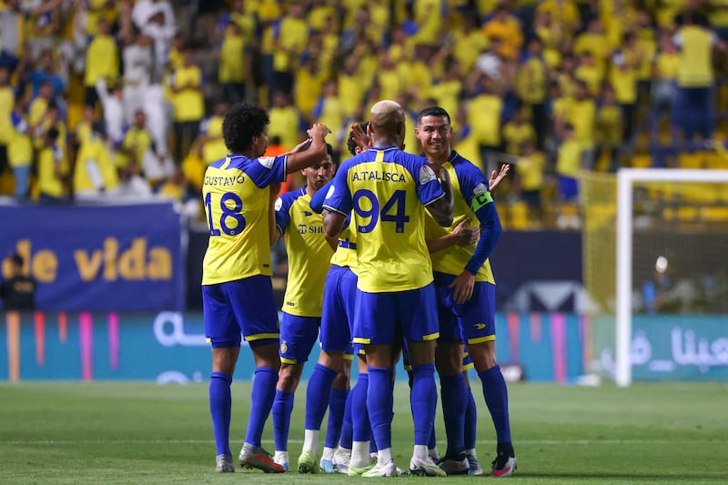 Al Nassr players celebrate after scoring during the Saudi Pro League football match against Al Khaleej.