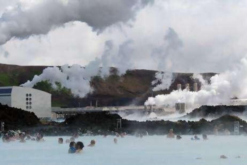 TO GO WITH AFP STORY BY PIERRE-HENRY DESHAYES -- This picture taken on August 4, 2010 shows tourists at Blue Lagon in Svartsendi, Iceland next to the Svartsengi Power Station (back), near Grindavik. Bjork, Iceland's megastar and most famous citizen, is on a new mission: to save her Nordic state's natural resources from investors she says are ready to feed off Iceland's wounded economy. Bjork has launched a campaign against a bid by Canada's Magma Energy company, a traded company in Toronto, which has taken steps to acquire HS Orka, a power company using one of the island's most valuable natural resources: geothermal energy. AFP PHOTO/ HALLDOR KOLBEINS *** Local Caption ***  149284-01-08.jpg