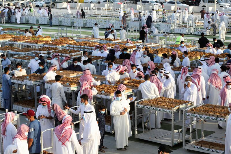 Traders flock to buy dates from a market in Unaizah, Saudi Arabia.