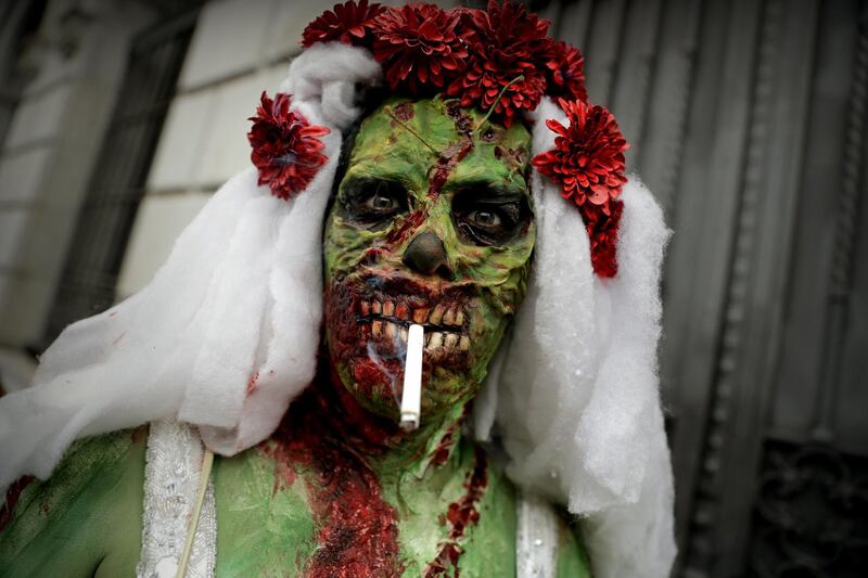People in costumes participate during the "Zombie Walk." EPA