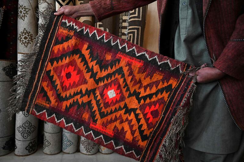 Rug hunters pass through villages and follow old caravan trails in Afghanistan, offering money or bartering with modern goods to obtain pieces they can later sell in souqs or to collectors. AFP
