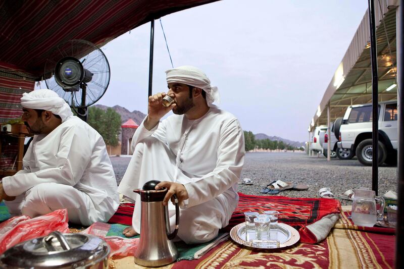 June 17, Guests drink Gawa, or Arabic coffee made with coffee beans and cardamon at Abdullah Al Yalyle's home Majlis in Wadi Al Tuwa.  June 1, Ras Al Khaimah, United Arab Emirates. (Photo: Antonie Robertson/ The National)