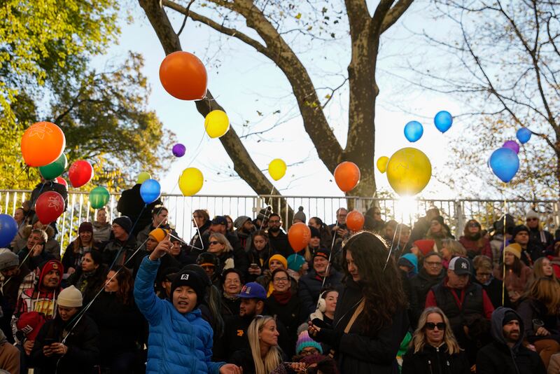 Spectators watch from the start point of the Macy's Thanksgiving Day Parade. AP Photo
