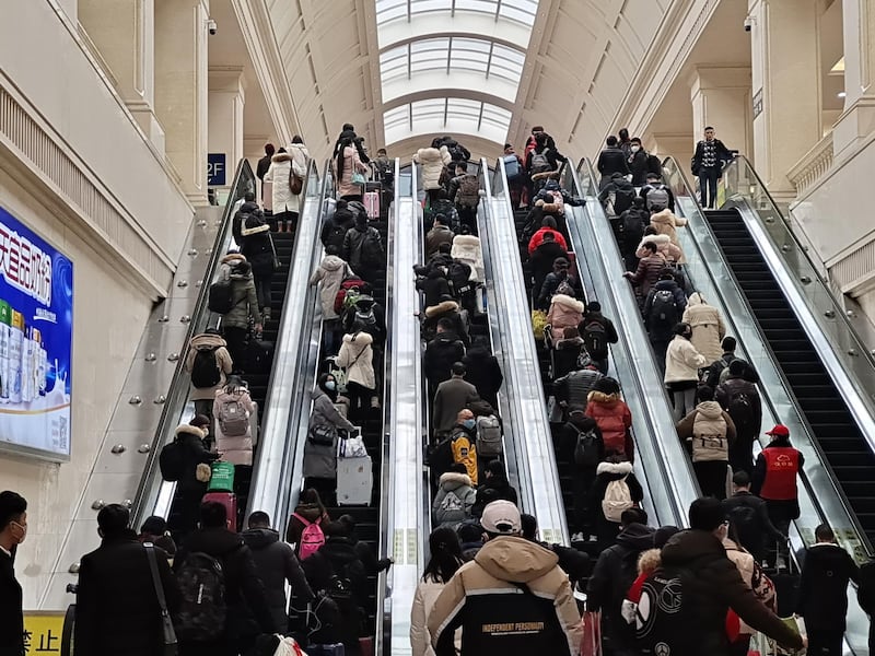 People wearing face masks ride escalators inside Hankou Railway Station in Wuhan, China. Getty Images