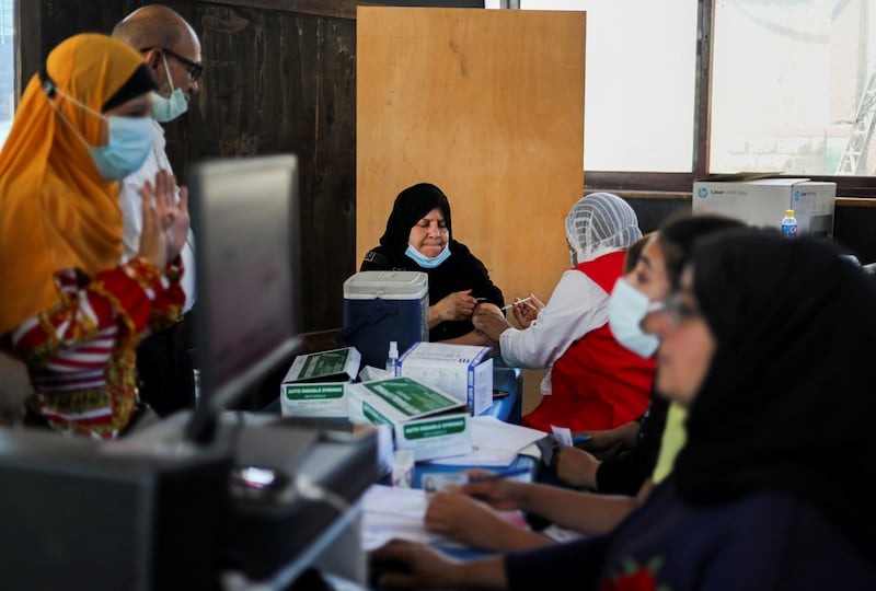A woman is immunised at a youth centre in the Egyptian capital. Reuters