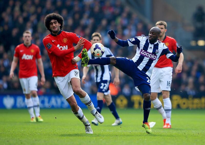 Marouane Fellaini of Manchester United battles with Youssuf Mulumbu of West Bromwich Albion during their Premier League match at The Hawthorns on March 8, 2014 in West Bromwich, England. Richard Heathcote/Getty Images