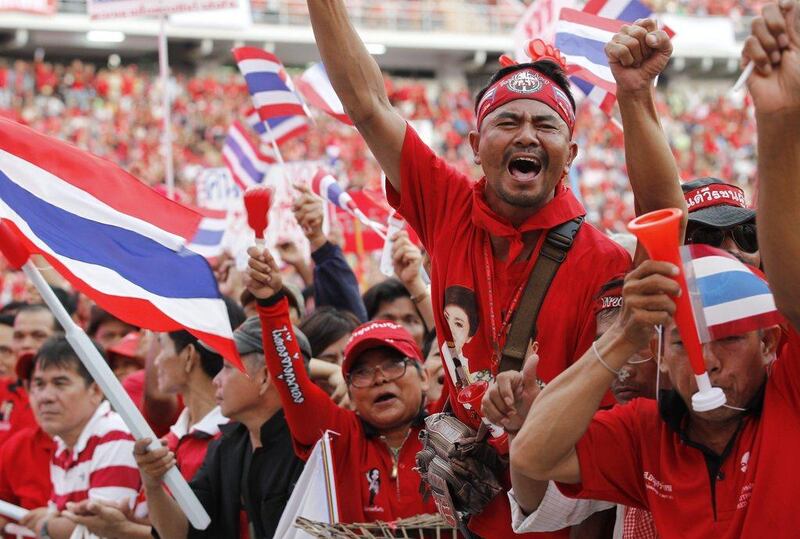 A pro-Thaksin supporter shouts slogans during a rally to support the Thai government at Rajamangala National Stadium in Bangkok, Thailand. Rungroj Yongrit / EPA