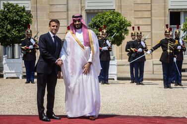 French President Emmanuel Macron (R) shakes hand with Saudi Crown Prince Mohammed bin Salman Al Saud (L), upon his arrival for a lunch dinner at Elysee palace in Paris, France, 16 June 2023.   EPA / CHRISTOPHE PETIT TESSON