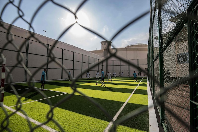 A picture taken on January 16, 2022 shows inmates playing football at the Correctional and Rehabilitation Centre in Badr city, 65 kms east of the Egyptian capital Cairo, during a government-guided tour for the media.  (Photo by Khaled DESOUKI  /  AFP)