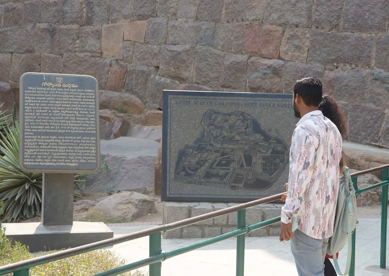 Tourists read a map of the colossal fort