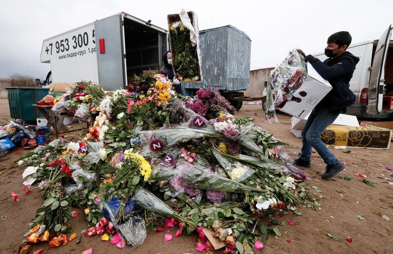 Russian florists dispose unsold flowers in St. Petersburg, Russia.  EPA