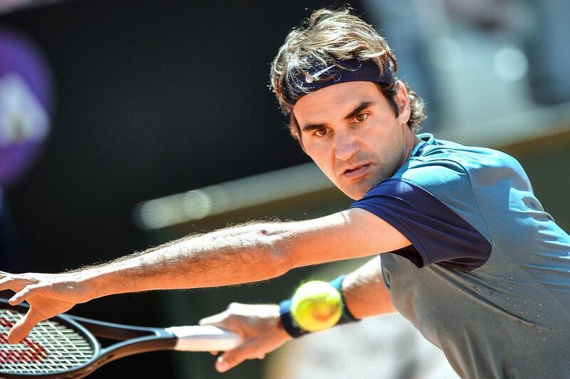 Swiss tennis player Roger Federer eyes the ball as returns to the ball to French Jeremy Chardy during the tennis Masters on May 14, 2014 at the Foro Italico in Rome. Andreas Solaro / AFP