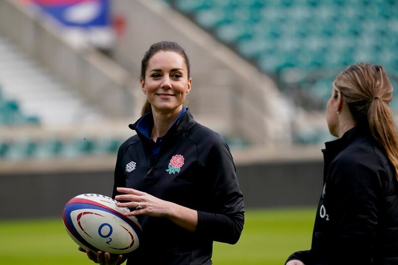 In her new role as patron of the Rugby Football Union, Britain's Kate the Duchess of Cambridge holds a rugby ball as she visits Twickenham Stadium, in London, to meet England rugby players and coaches and join in with a training session, Wednesday, Feb.  2, 2022.  (AP Photo / Alberto Pezzali)