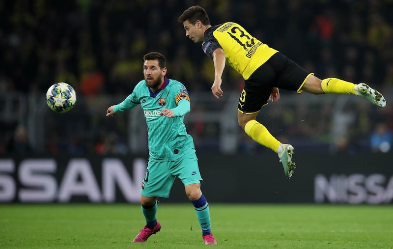 Dortmund's Raphael Guerreiro in action against Barcelona's Lionel Messi. EPA