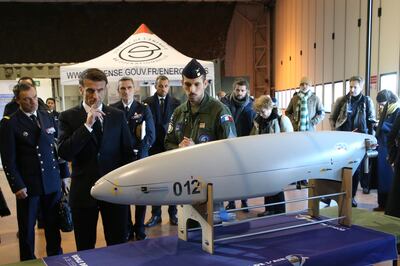 French President Emmanuel Macron is shown a military drone. EPA