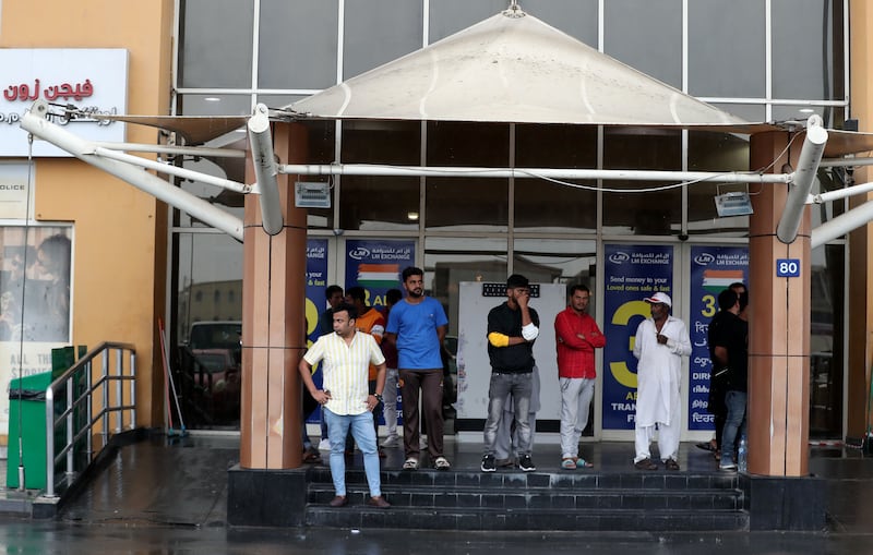 People wait out a downpour in Al Quoz. Chris Whiteoak / The National