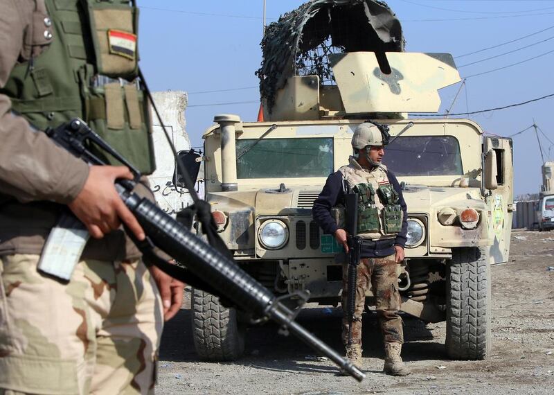 Iraqi soldiers monitor a checkpoint east of Baghdad on January 6, 2014, two days after ISIL fighters captured the city of Fallujah in Anbar province, some 70 kilometres west of the capital. Ali Al Saadi/AFP Photo