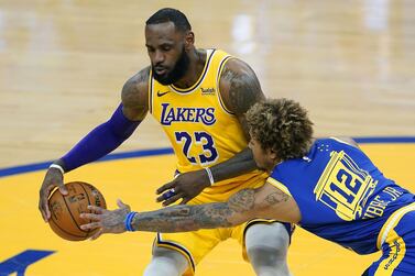 LeBron James of the Los Angeles Lakers dribbles the ball against Kelly Oubre Jr of the Golden State Warriors. AFP