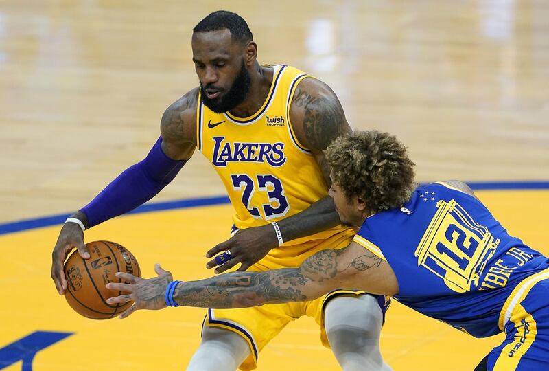 SAN FRANCISCO, CALIFORNIA - MARCH 15: LeBron James #23 of the Los Angeles Lakers dribbling the ball is defended by Kelly Oubre Jr. #12 of the Golden State Warriors during the first half of an NBA basketball game at Chase Center on March 15, 2021 in San Francisco, California. NOTE TO USER: User expressly acknowledges and agrees that, by downloading and or using this photograph, User is consenting to the terms and conditions of the Getty Images License Agreement.   Thearon W. Henderson/Getty Images/AFP
== FOR NEWSPAPERS, INTERNET, TELCOS & TELEVISION USE ONLY ==
