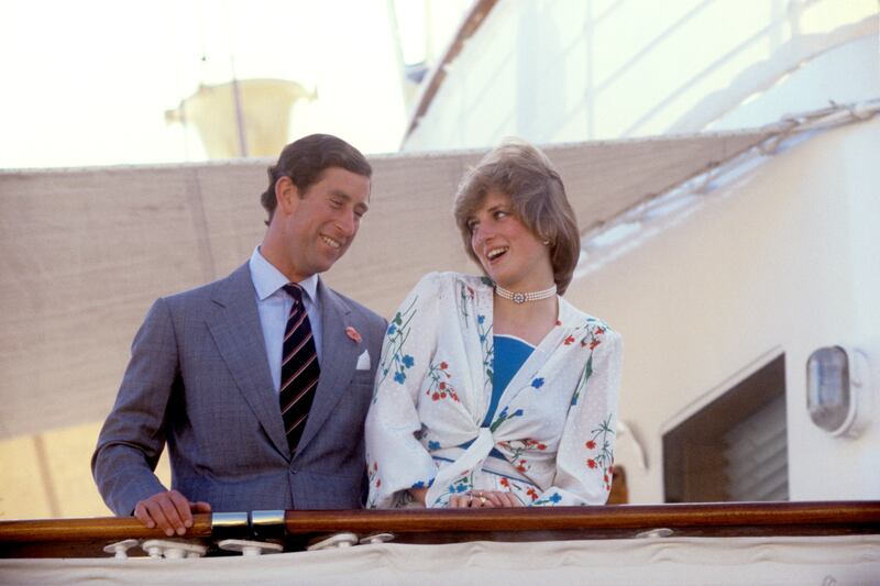 The Prince and Princess of Wales in a merry mood aboard the Royal Yacht Britannia as they sail away on their honeymoon
