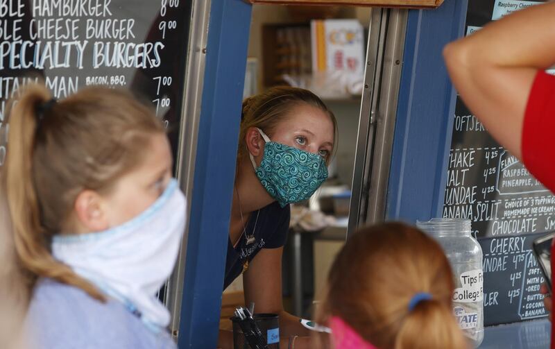 A staff wears a mask while taking orders at a small restaurant in Grand Lake, Colorado, US, amid the coronavirus pandemic. AP Photo