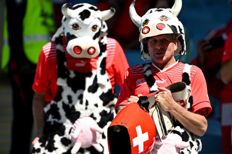 Switzerland supporters celebrate their country's dairy heritage by wearing cow costumes for the match against Cameroon. AFP