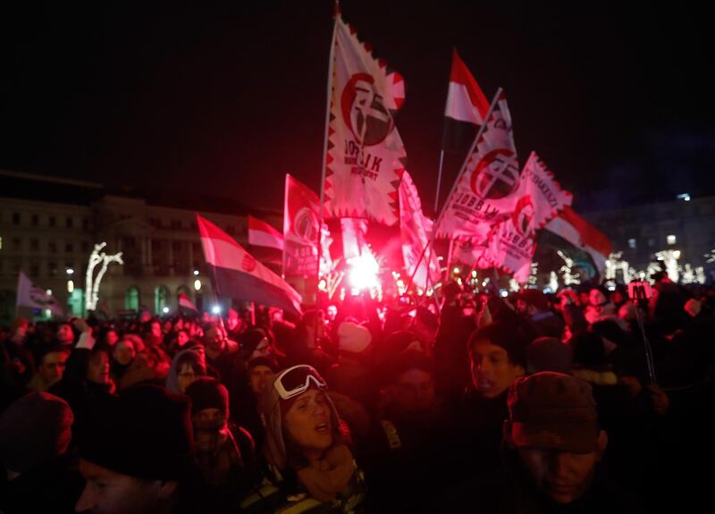 BUDAPEST, HUNGARY - DECEMBER 14:  Demonstrators protesting against recent legislative measures introduced by the government of Hungarian Prime Minister Viktor Orban stand outside Parliament on December 14, 2018 in Budapest, Hungary. The protest follows two recent legislative initiatives by Orban: one that allows employers to force employees to work more overtime, the other the creation of a parallel courts system known as administrative courts to deal with cases related to corruption and free speech, among other issues.  (Photo by Laszlo Balogh/Getty Images)