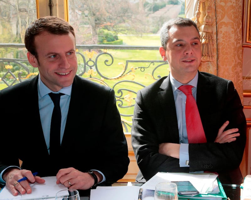(FILES) In this file photo taken on March 07, 2016 then French Economy minister Emmanuel Macron (L) and his then Chief of staff Alexis Kohler attend a meeting with the French prime minister on proposed changes of the labour law at the Hotel Matignon in Paris.
 Police raided France's economy ministry June 6, 2018 as part of a conflict of interest probe into President Emmanuel Macron's chief of staff Alexis Kohler, a source close to the case said. The search operations in several offices were carried out by officers from the BRDE economic crimes unit, the source said. Kohler previously worked in the ministry as a senior civil servant, including as cabinet director to Macron during his time as economy minister between 2014 and 2016. / AFP / JACQUES DEMARTHON
