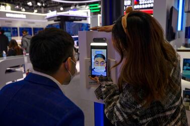 A man tries a new facial recognition system that can be used with masks at a booth operated by Chinese technology company Baidu at the World Internet Conference in Wuzhen, Zheijang. Smart Dubai hopes to roll out facial recognition to authenticate transactions. EPA