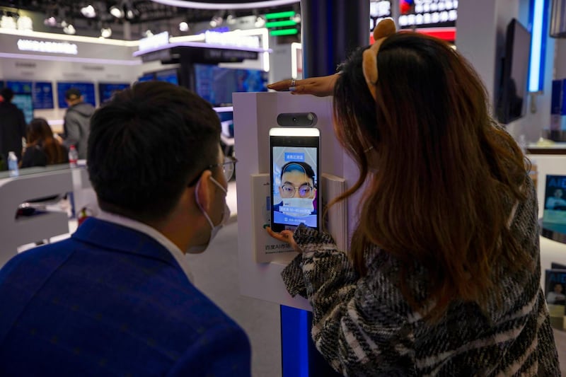epa08837508 A man tries new facial recognition with a mask feature at a Baidu booth at the 'Light Of The Internet Expo' during World Internet Conference in Wuzhen, Zhejiang Province, China, 23 November 2020. The World Internet Conference, also known as Wuzhen Summit is a two day conference held on 23 to 24 November.  EPA/ALEX PLAVEVSKI