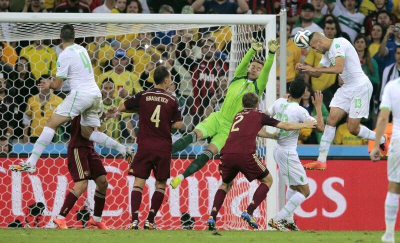 Islam Slimani, right, of Algeria heads in the equaliser against Russia to make it 1-1 on Thursday in their 2014 World Cup Group H match in Curitiba, Brazil. Ivan Sekretarev / AP