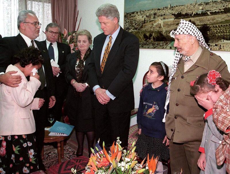 Palestinian chief negotiator Saeb Erekat  comforts a Palestinian girl whose father is being held in an Israeli jail as she tells her story to Secretary of State Madeleine Albright, US President Bill Clinton, and Palestinian President Yasser Arafat on December 14, 1998. Reuters