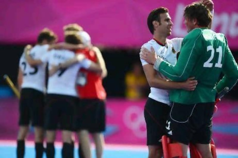 Christopher Zeller, left, celebrates Germany's semi-final victory with Max Weinhold, the goalkeeper, who played the game with a broken hand. Lars Baron / Getty Images