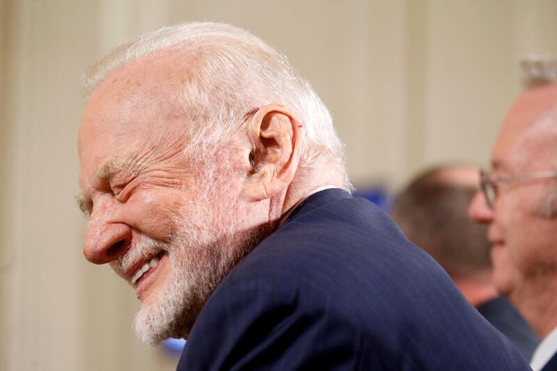 Former astronaut Buzz Aldrin laughs at a joke told by U.S. President Donald Trump as President Trump addresses a meeting of the National Space Council in the East Room of the White House in Washington, U.S., June 18, 2018. REUTERS/Leah Millis     TPX IMAGES OF THE DAY