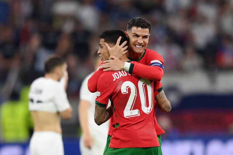 Cristiano Ronaldo and Joao Cancelo of Portugal celebrate after their team's penalty shoot-out victory against Slovenia in the last 16 of Euro 2024 at Frankfurt Arena on July 1, 2024. The game ended 0-0 after extra time but Portugal won 3-0 on penalites. Getty Images