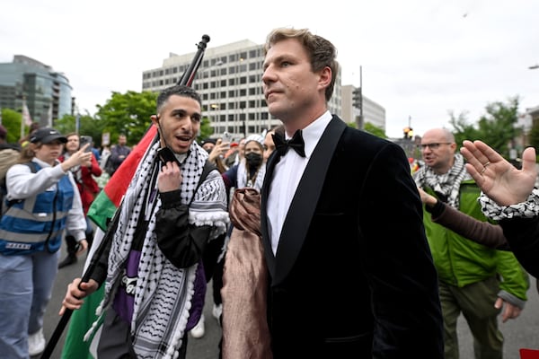 A person attending the White House Correspondents' Association Dinner is confronted by a demonstrator during a pro-Palestine protest in Washington. AP
