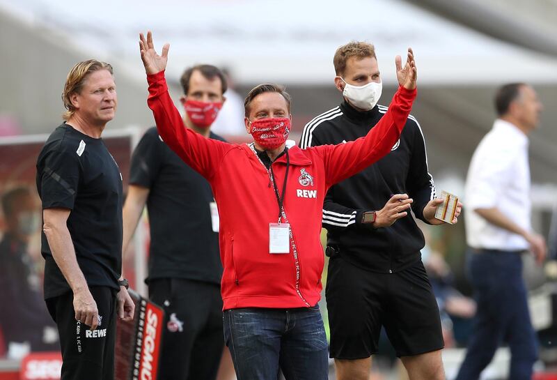 COLOGNE 2 MAINZ 2. Cologne general manager Horst Heldt wearing a protective face mask during the match. Reuters