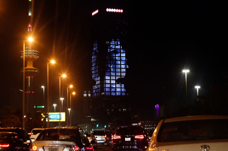 A picture of the late Queen Elizabeth II illuminates a tower in Kuwait City. AFP