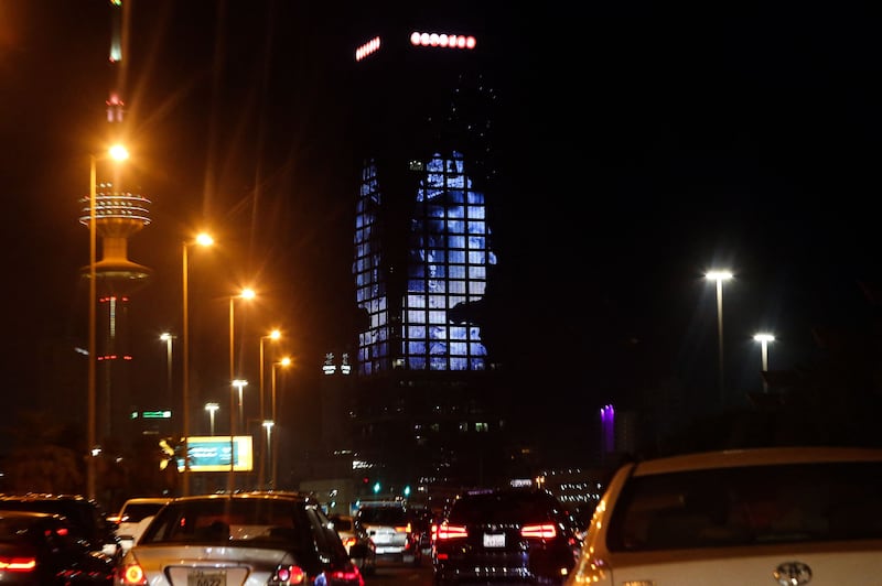 A picture of the late Queen Elizabeth II illuminates a tower in Kuwait City. AFP
