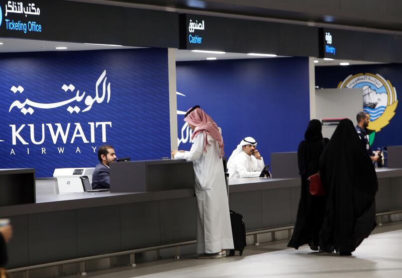 A picture taken on September 30, 2018, shows travellers checking-in at the new Terminal 4 of Kuwait International Airport, south of Kuwait City.  Kuwait Airways flights heading to neighbouring Gulf countries began taking off from the new terminal today. The itinerary includes between 26 to 34 daily trips to Gulf Cooperation (GCC) countries, the chairman of the company said.  / AFP / Yasser Al-Zayyat
