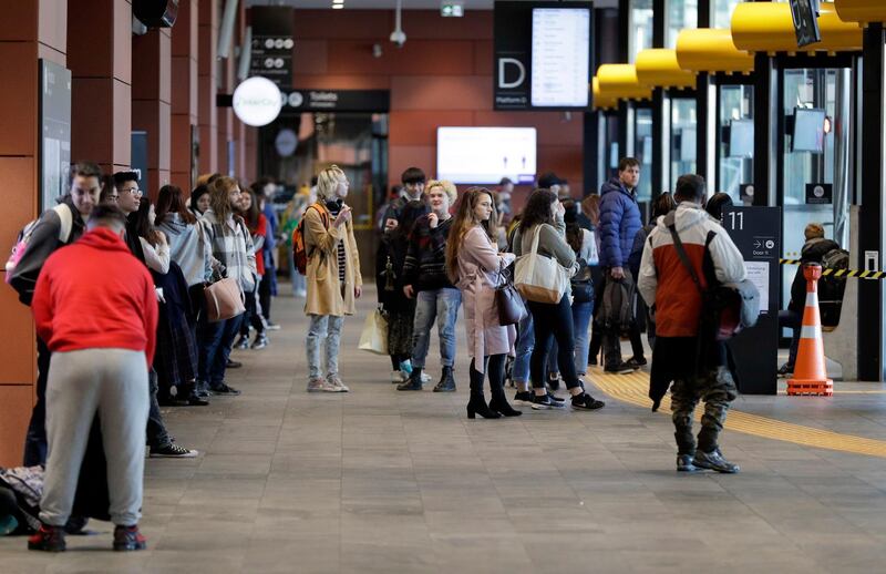 Commuters wait for transport at a bus interchange in Christchurch, New Zealand. AP Photo