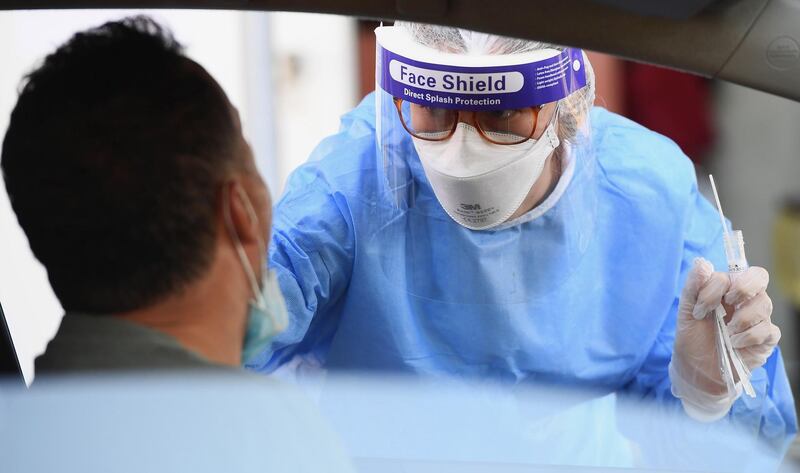 epa08608885 Health workers wearing overalls and protective masks perform swab tests at the 'Santa Maria della Pieta' of the ASL Roma 1 health facilities in Rome, Italy, 17 August 2020. Italy has introduced mandatory coronavirus disease (COVID-19) testing for anyone arriving from Croatia, Greece, Spain and Malta in an attempt to avoid a spike of new cases.  EPA/ETTORE FERRARI