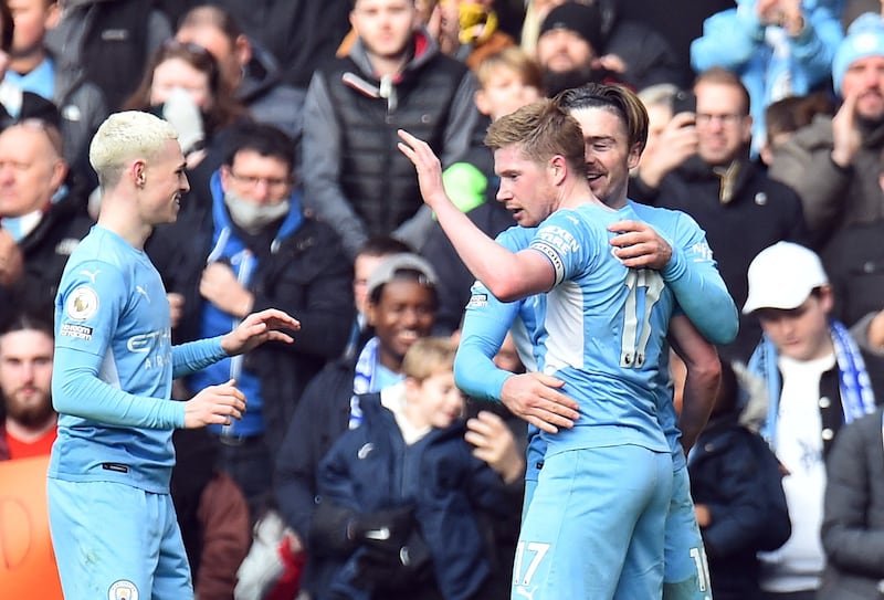 Jack Grealish and Phil Foden celebrate with Kevin De Bruyne after his opening goal. AP