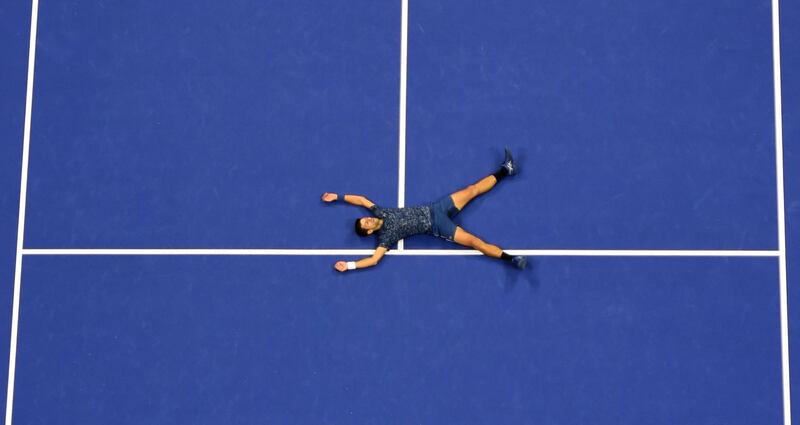 Novak Djokovic falls to the court in celebration after his victory over Juan Martin del Potro in the 2018 US Open men's final in New York. Don Emmert / AFP