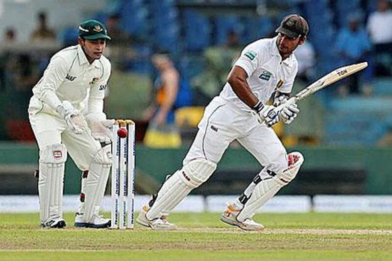 Sri Lankan's Kumar Sangakkara, right, plays a shot in front of Bangladesh captain Mushfiqur Rahim. Eranga Jayawardena / AP Photo
