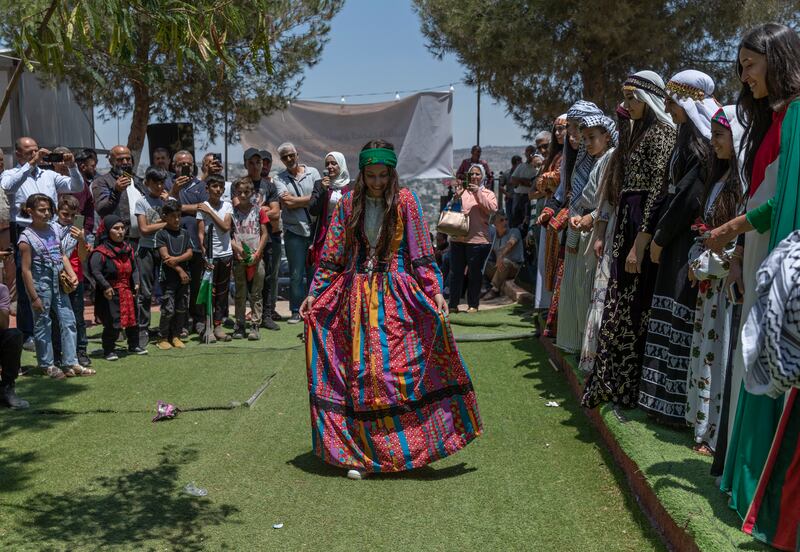 A model in traditional Palestinian dress during a show on the opening day of the Beita market, in the West Bank village of Beita, near Nablus.