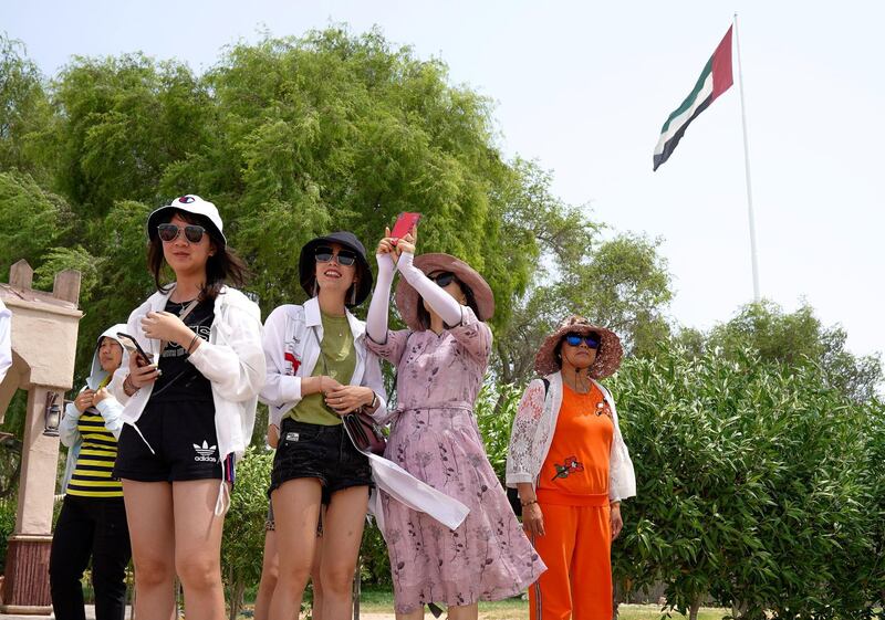 Abu Dhabi, United Arab Emirates, July 23, 2019.  Chinese tourists enjoy the sights at the Heritage Village, Corniche, in spite of the humid weather.
Victor Besa/The National
Section:  NA
Reporter:
